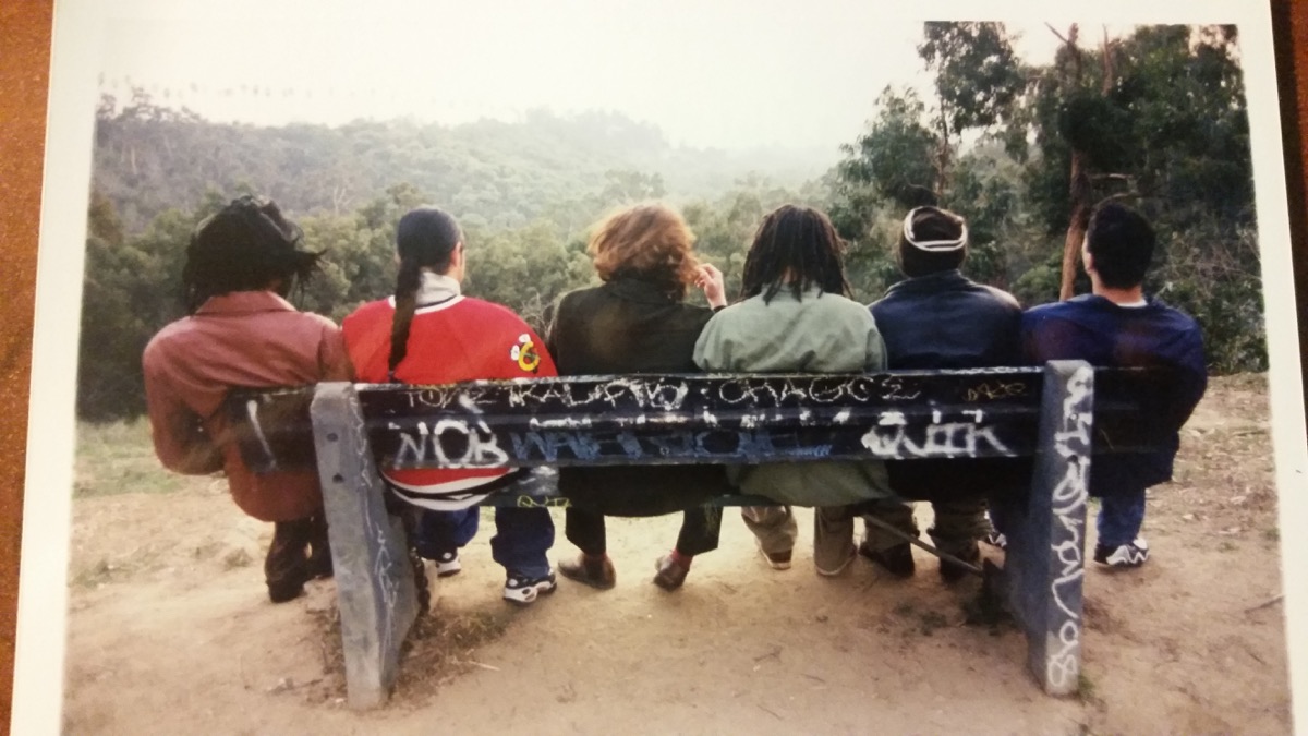Archival photograph of a Los Angeles creative collective seated on a park bench
